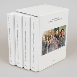 Set of four white books with a cover featuring a photo of people and text, on a light gray background.